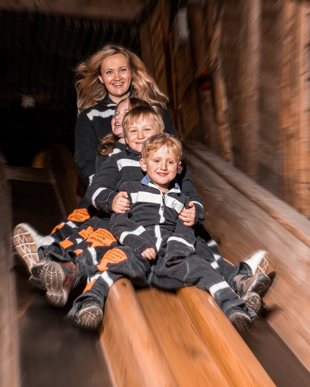 Family on miner's slide in the Berchtesgaden Salt Mine